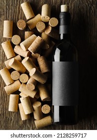 A Bottle Of Red Wine And Many Wine Corks. High Angle View. There Are No People In The Photo. Restaurant, Hotel, Bar, Wine Cellar. Advertising Business, Banner.