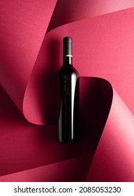 Bottle of red wine on a red background. Top view. - Shutterstock ID 2085053230
