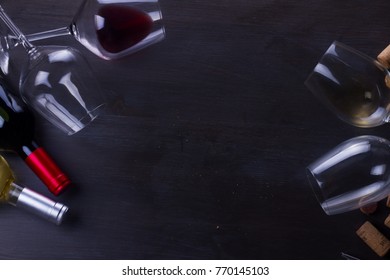 Bottle Of Red Wine And Two Wine Glasses On Dark, Flat Lay Frame With Copy Space