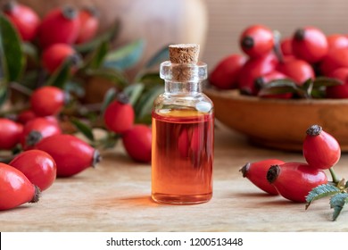 A bottle of rose hip seed oil with ripe berries