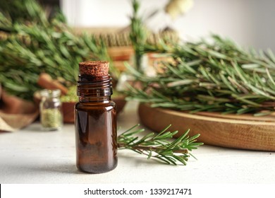 Bottle With Rosemary Oil On Table