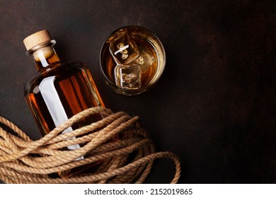 Bottle with rum, cognac or whiskey. Top view flat lay with copy space