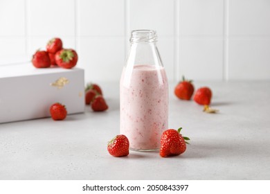 Bottle Of Strawberry Yoghurt Or Milk On Grey Table And Berry On 