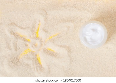 Bottle Of Sun Block Creme On Sand. Sunscreen On Sand With Sun Pattern