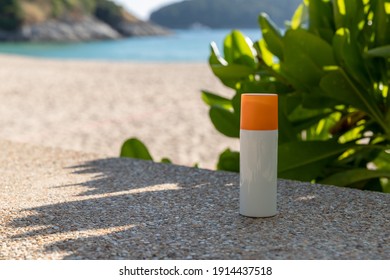 Bottle Of Sunscreen Lotion On The Beach By The Sea