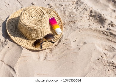 A Bottle Of Sunscreen With Sunglasses And Panama Hat  On A Beach, Summer Skin Remedies And Protection, Vacation At A Sea