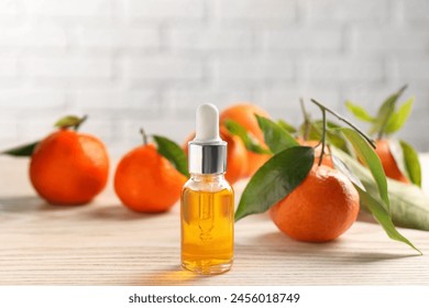 Bottle of tangerine essential oil and fresh fruits on white wooden table - Powered by Shutterstock