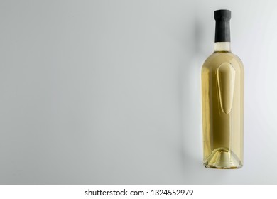 Bottle of tasty wine on light background - Shutterstock ID 1324552979