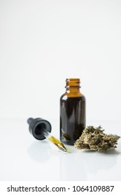 A Bottle Of Tincture With A Dropper And Cannabis Bud Demonstrating It`s Contents