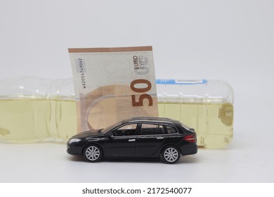 A Bottle Of Vegetable Oil And A Typewriter Lie On A Banknote. Biodiesel, Biofuel, Vegetable Oil, Fuel Crisis, Rising Fuel Prices, Biofuel Shortage