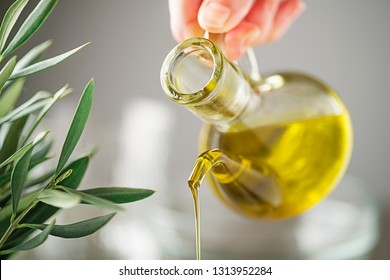 Bottle Of Virgin Olive Oil Pouring Close Up