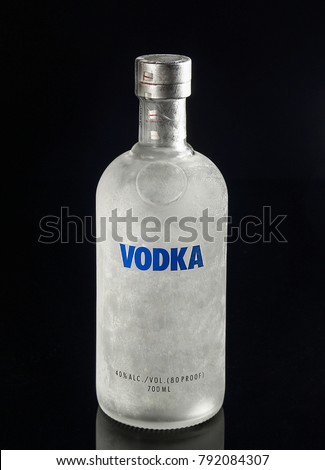 A bottle of vodka from the freezer on a black background