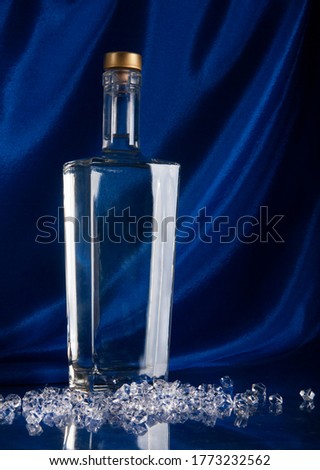 bottle of vodka on blue background