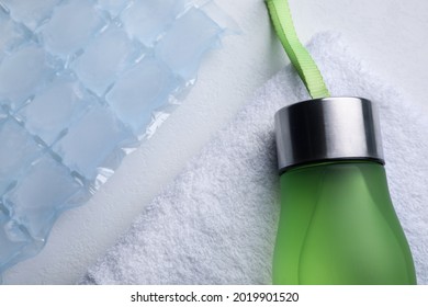 Bottle Of Water, Ice Pack And Towel On White Background, Flat Lay. Heat Stroke Treatment