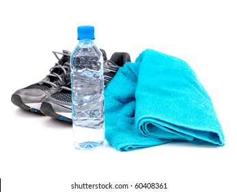 A Bottle Of Water, Joggers And A Sports Towel Isolated Against A White Background