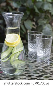 Bottle Of Water With Lemon And Cucumber On The Table