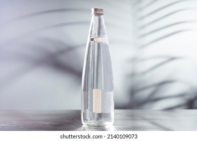 A Bottle Of Water On A Marble Table On A Soft Focus Background