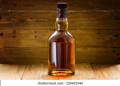 bottle  of whiskey  on a wooden background
