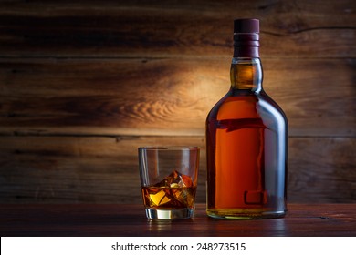 Bottle of whiskey on a wooden background