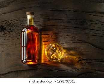 Bottle Of Whisky And Glass Of Whisky On Wooden Board. Top View.