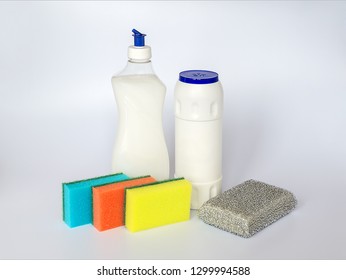 Bottle With White Dishwashing Liquid, Scouring Powder And Four Foam Sponges Of Different Colours On A White  Background. Kitchen Detergent. Household Chemicals. Household Chores.