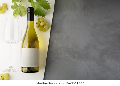 Bottle Of White Wine With Label. Glass Of Wine And Grape. Wine Bottle Mockup. Top View.