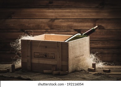 Bottle of wine in box in wooden interior 