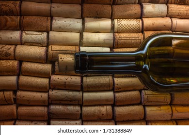 A Bottle Of Wine Without A Label Lies On A Large Number Of Wine Corks. Cork Tree And Its Texture For Background