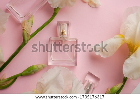 bottle of woman perfume  with spring  flowers. irises  gift. 
