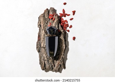 Bottle Of Woody Perfume On Light Background, Top View