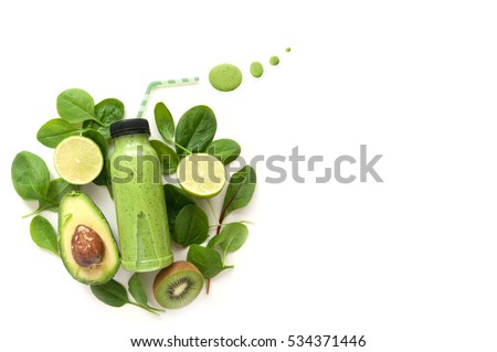 Bottled detox drink surrounded by green foods including spinach and kiwi 