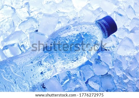 Bottled water with ice cubes. Conceptual image