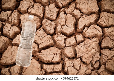 A bottled water on dried crack ground