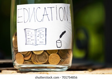 The Bottle,jar With Money Are Saving For The Education,college,university With Drawing. Concept Development And Growth.Outdoor