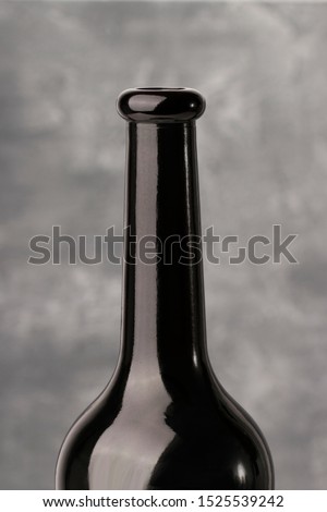 bottleneck of a red wine , close up. gray background 