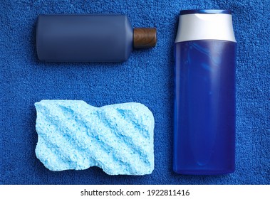 Bottles And Bast Wisp On Blue Towel, Flat Lay. Men's Cosmetics