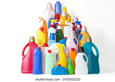 A lot of bottles with chemicals for cleaning. Pile of many colorful bottles on the white background with copy space for your text. Different plastic bottles in the form of mountain. 