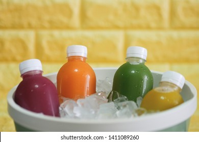 the bottles of cold pressed fruit and vegetables juice in the ice bucket.
