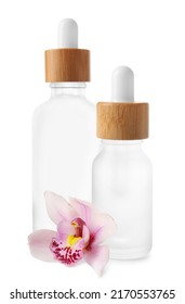 Bottles of cosmetic serum and orchid flower isolated on white