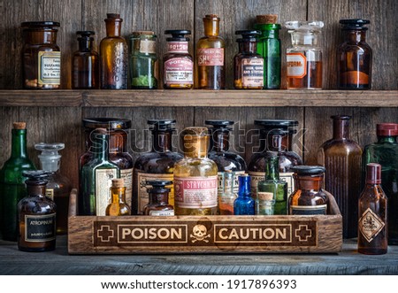 Bottles with drugs from old medical, chemical and pharmaceutical glass. Chemistry and pharmacy history concept background. Retro style. Chemical substances.
