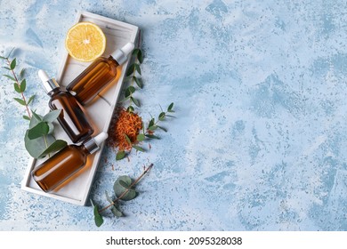 Bottles Of Essential Oils On Color Background