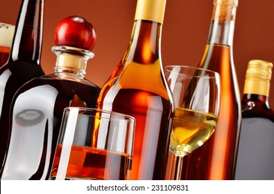 Bottles and glasses of assorted alcoholic beverages. - Shutterstock ID 231109831