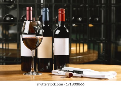 Bottles and glasses with wine on the table. Wine drinking culture concept. Apperetes and survivors. Copy space, dark background - Powered by Shutterstock