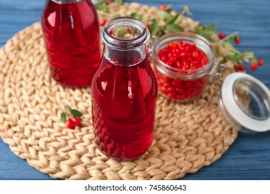 Bottles With Goji Juice On Wicker Mat