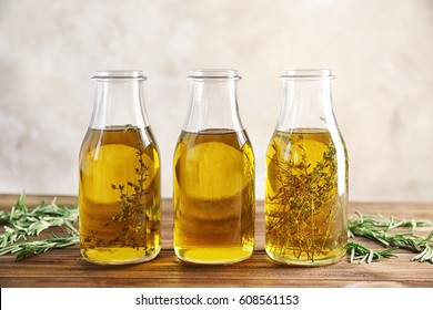 Bottles with herbs and oil on table - Powered by Shutterstock