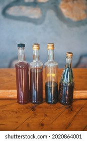 Bottles with homemade brandy on wooden table