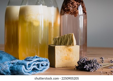 Bottles of homemade laundry on a table, Marseille grated soap, DIY, do it yourself, zero waste, eco friendly, natural product for wash and cleaning - Shutterstock ID 2250905205