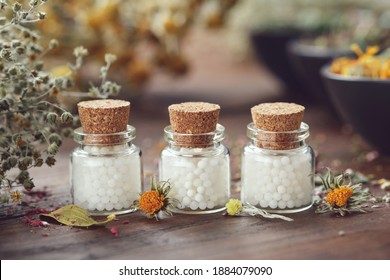 Bottles Of Homeopathic Globules And Medicinal Herbs. Homeopathy Medicine Concept.