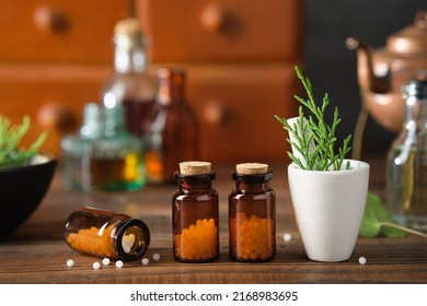 Bottles of homeopathic granules, cabinet with homeopathic remedies and tincture bottles on background. Homeopathy medicine concept.  - Shutterstock ID 2168983695