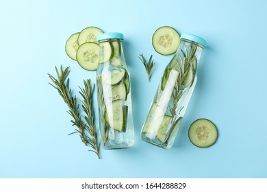 Bottles with infused cucumber water on blue background, top view - Shutterstock ID 1644288829